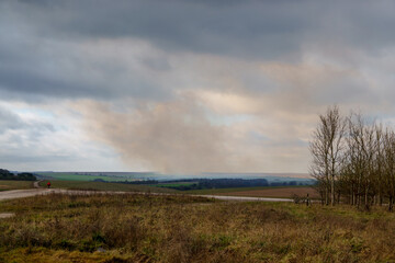 plumes of distant gun smoke after a british army battery fire several artillery rounds from 105mm Light Artillery Guns