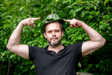 Portrait of a farmer man with a mature juicy pattison on his head
