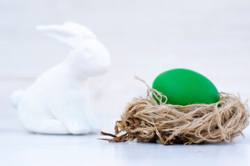 Easter eggs in soft colors on a white shabby wooden table