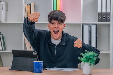euphoric millennial student at home with laptop