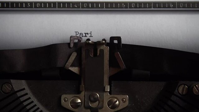 Typing city name Paris on an old typewriter. Close