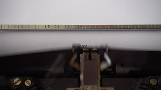 Typing word Pandemic on retro typewriter. Close up.