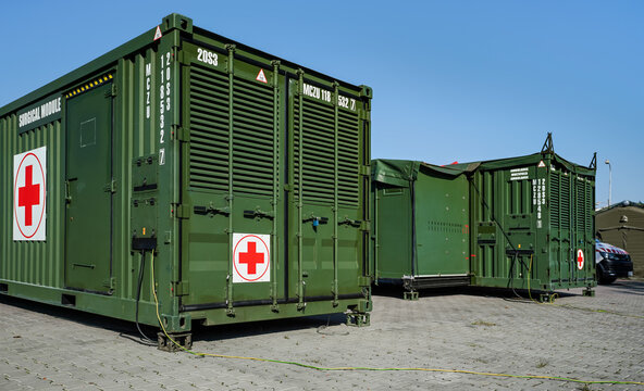 Brno, Czechia - October 08, 2021: Green metal army container box - Surgical module - with red cross, setup as field ambulance demonstration during IDET military and defence exhibition fair