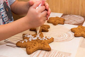 Top view, colorful handmade easter objects, bakery, cookies laying on table and hands showing painted, decorated small, little cookie.Kids decorate gingerbread cookies for mom.Happy mother's day	
