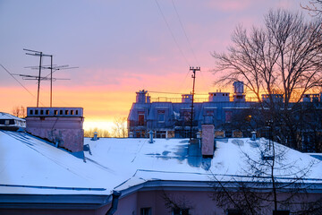 Fototapeta premium Winter sunset over the roofs of St. Petersburg