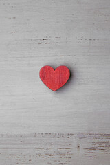 Red wooden heart on a light wooden background