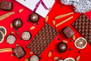 Composition of chocolate, milk chocolate in the form of bubbles on a red background