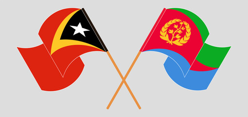 Crossed and waving flags of East Timor and Eritrea