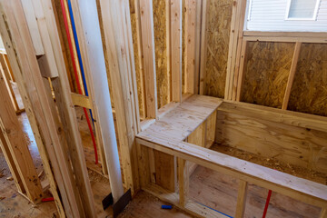 New stick built building view framing of beams on new home under construction