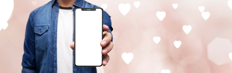 valentines day concept - cell phone in hand with pink background with hearts- easy modification