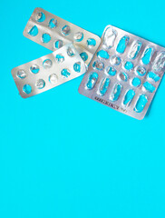 empty used blisters from pills on a blue background