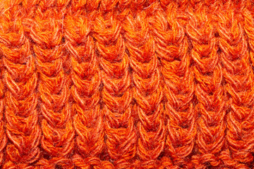 Knitted background close up. orange woolen fabric