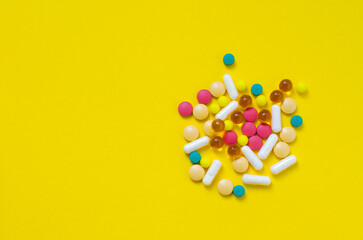 a lot of medical drugs on a yellow background flatlay