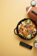 Football Party Appetizers Background with Loaded Nachos and Soda