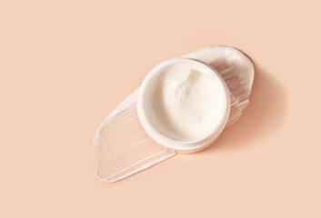 White smeared cream or cosmetic face mask with the open cosmetic jar.  Purifying and moisturizing...