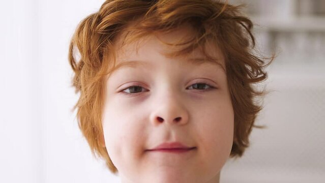 closeup of redhead boy's face. Five years old kid