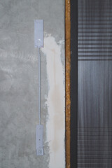 Entrance door and intercom phone receiver on the wall. handset hanging on the gray concrete background