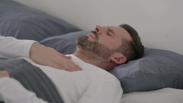 Man Coughing while Sleeping in Bed
