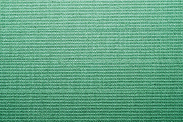 Cardboard covered green paint background close up