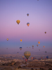 Bright multi-colored hot air balloons flying in sunsrise sky Cappadocia Turkey.