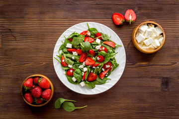 Spinach salad with strawberry and goat cheese, top view