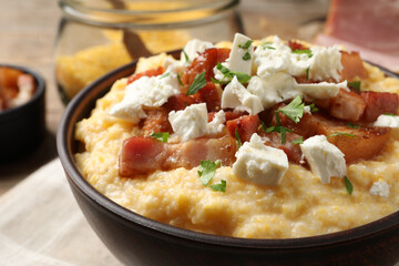 Delicious traditional Ukrainian banosh in bowl on table, closeup