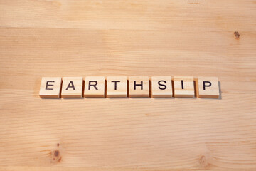 earthship letters on wooden background