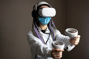 Medical worker in virtual reality helmet is holding joysticks
