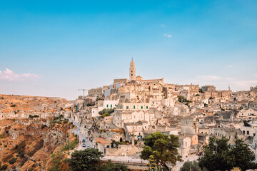 Fototapeta na wymiar Sassi di Matera from the Belvedere Colombo (Church of Sant'Agostino), blue sky with clouds