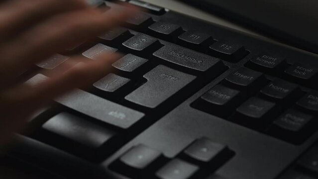 Woman using computer, typing on keyboard, hitting the enter key on a desktop pc keyboard. Enter key mean digital confirmation, sending message. Detail of Enter button.