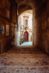 Fototapeta na wymiar Covered alleyway in the Sassi of Matera, vertical