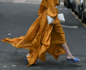 woman wearing orange dress and purple open toe shoes