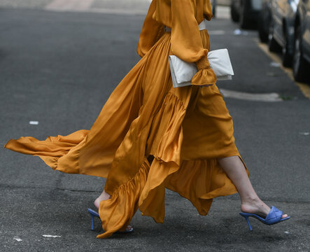 woman wearing orange dress and purple open toe shoes