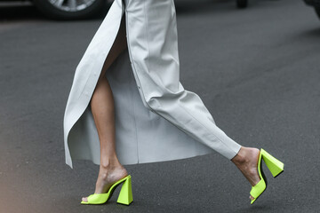 woman wearing neon green shoes and long cut skirt