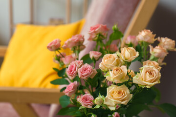 Bouquet of beautiful fresh roses in room, closeup