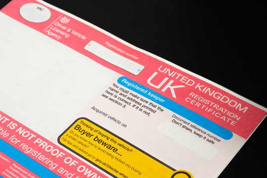 Genuine UK registration certificate for a purchased car seen on photo. Registration document also known as a vehicle log book V5C. Stafford, United Kingdom, January 30, 2022.