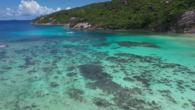Aerial view of a luxury yacht anchored at Baie Ternay Marine National Park, Seychelles.