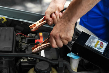 Man testing modern car battery