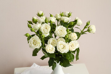 Vase with bouquet of beautiful roses on light background, closeup