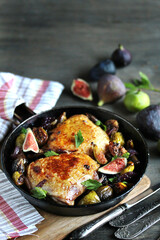 chicken with figs. dish with figs. fried chicken with figs and onions in pan. Soft focus.