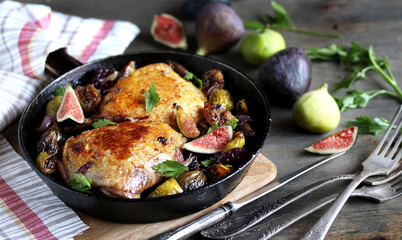 chicken with figs. dish with figs. fried chicken with figs and onions in pan. Soft focus.