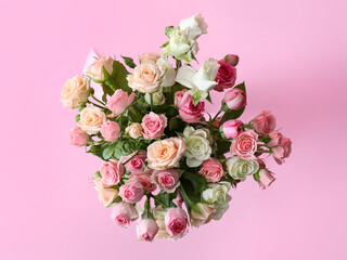 Bouquet of beautiful roses on pink background