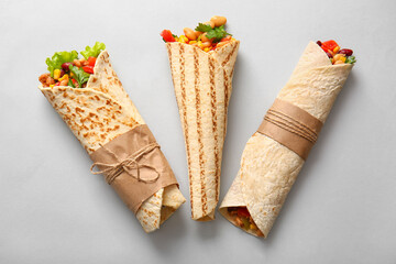 Delicious burritos on grey background