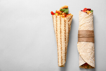 Delicious burritos on grey background