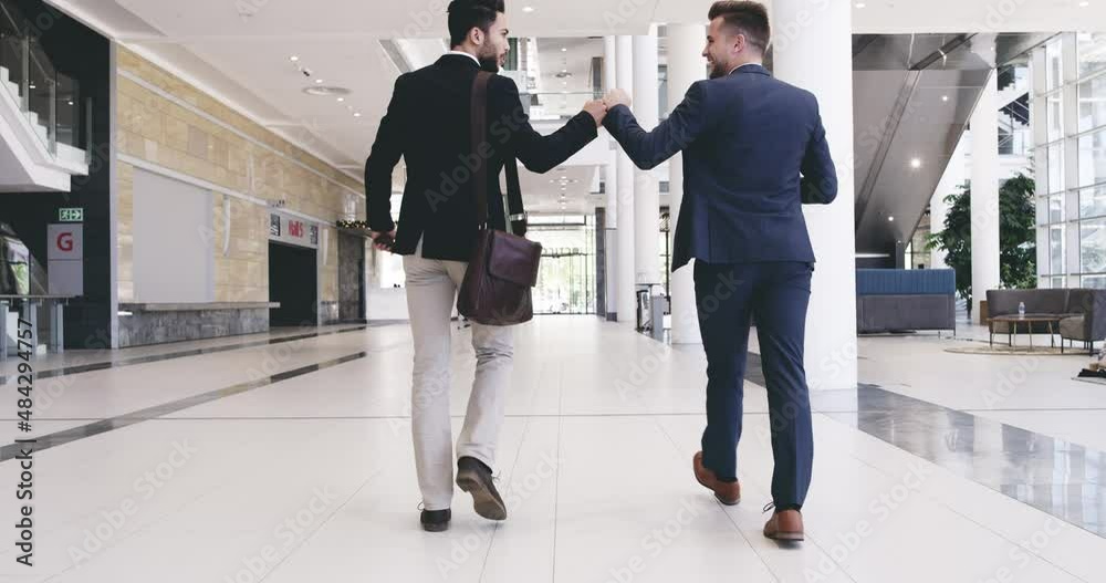 Poster venture together and start this adventure. businessmen giving each other a fist bump while walking i
