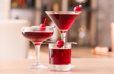 Glasses of tasty Manhattan cocktail on table