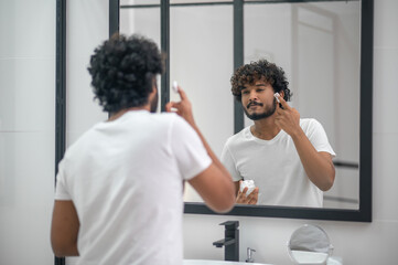 Focused man preparing for a shaving procedure