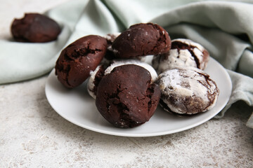 Plate of chocolate brownie cookies on light background