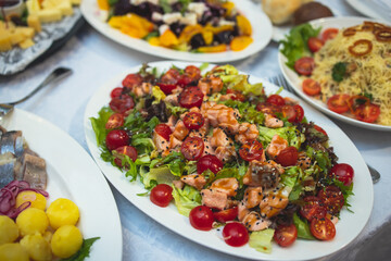 Catering table, beautifully decorated banquet with variety of with different food snacks and appetizers on corporate birthday party event or wedding celebration, canape, delicatessen setting