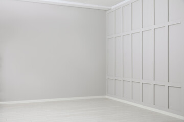 Empty spacious room with white wooden floor and walls